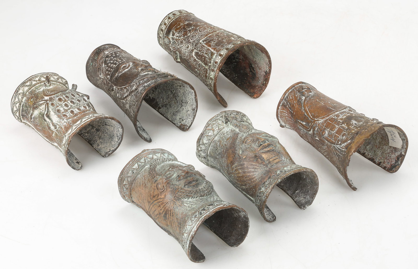 6 Figural Bronze Cuff Bracelets, Nigeria, L: 7"-9": 6 Figural Bronze Cuff Bracelets, Nigeria. Sizes From: 7'' x 4'' x 4'' (18 x 10 x 10 cm); To: 9'' x 4'' x 3'' (23 x 10 x 8 cm). Total Weight: 12.5 lbs. Provenance: Collection of Charles L. Blockson (19