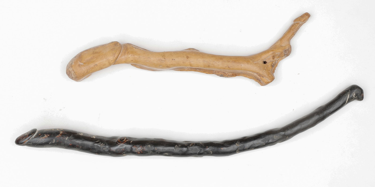 2 Thai Black And White Coral Palad-Khik Phallic Amulets, C. 1950: 2 Thai Black And White Coral Palad-Khik Phallic Amulets, C. 1950. Sizes: 1) 9.5'' x 3.5'' x 1'' (24 x 9 x 3 cm); 2) 13.5'' x 2'' x 1'' (34 x 5 x 3 cm). Unusual or rare materials are believed to augmen