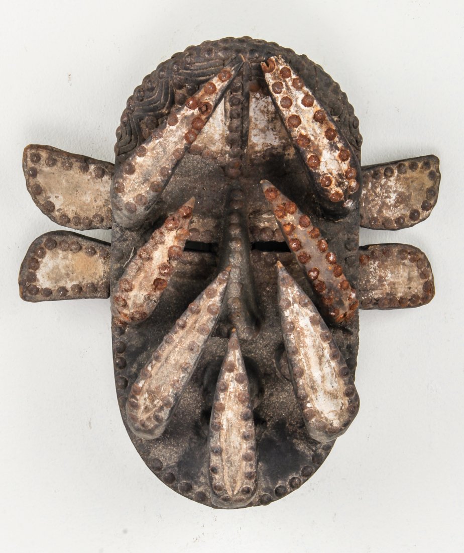 African Bete Mask: African Bete Mask. Carved wood, metal studs. Size: 14" x 14" x 6.5. Provenance: Max Garb, Chicago, Illinois.