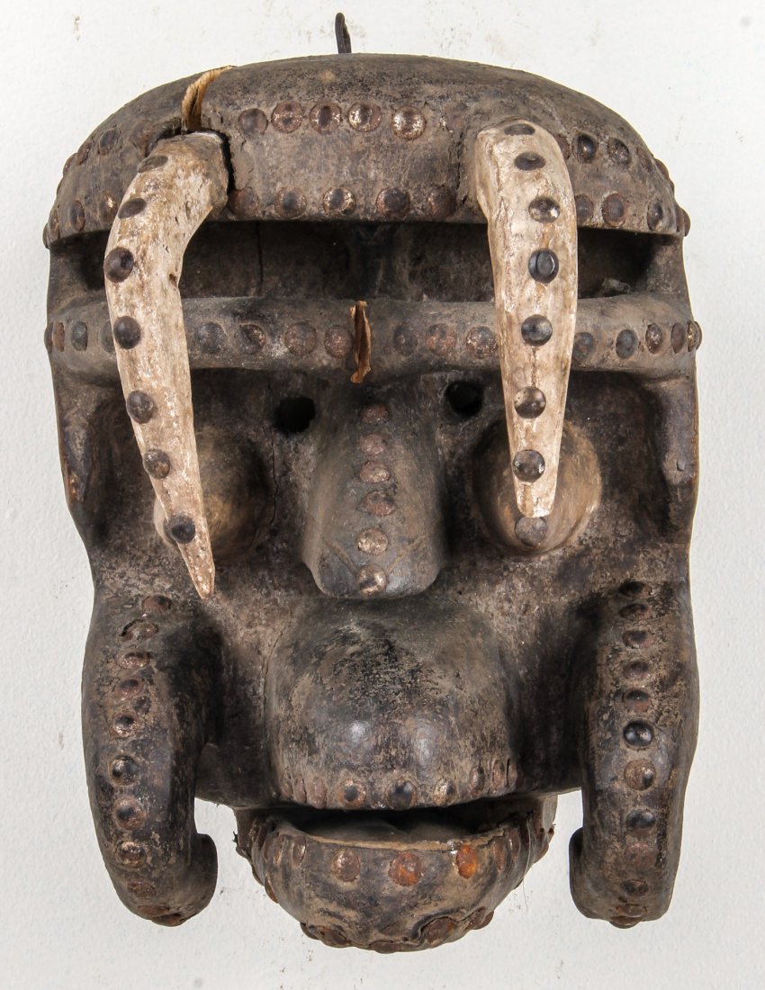 African Bete Mask: African Bete Mask. Carved wood, metal studs. Size: 13" x 9" x 11". Provenance: Max Garb, Chicago, Illinois.