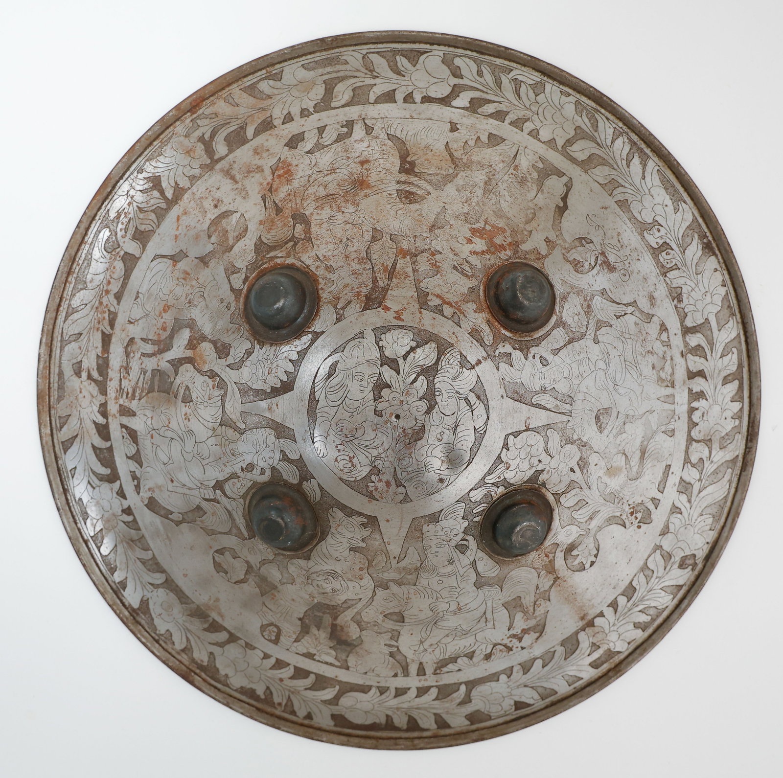 Indo-Persian Dhal Shield, Late 19th C.: Indo-Persian Dhal Shield, Late 19th C. Engraved figural scenes and 4 domed bosses. Size: 19'' x 19'' x 3.5'' (48 x 48 x 9 cm).