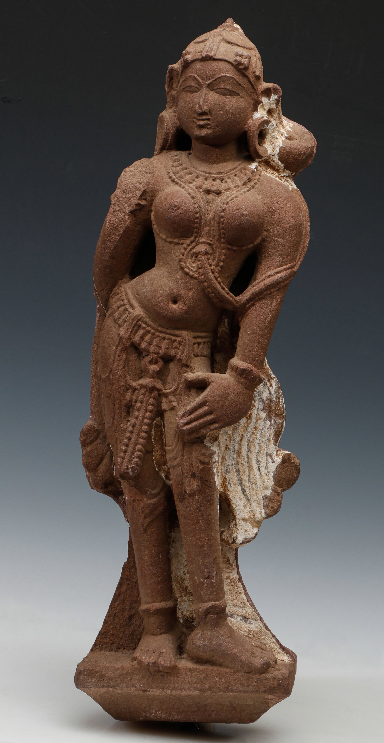 Indian Sandstone Female Figure (Yakshi / Devata Figure) Northern or Central India, 10th-13th C. H:: Indian Sandstone Female Figure (Yakshi / Devata Figure) Northern or Central India, 10th-13th C.Carved sandstone. Finely carved sandstone sculpture depicting a graceful female figure, likely a yakshi, 