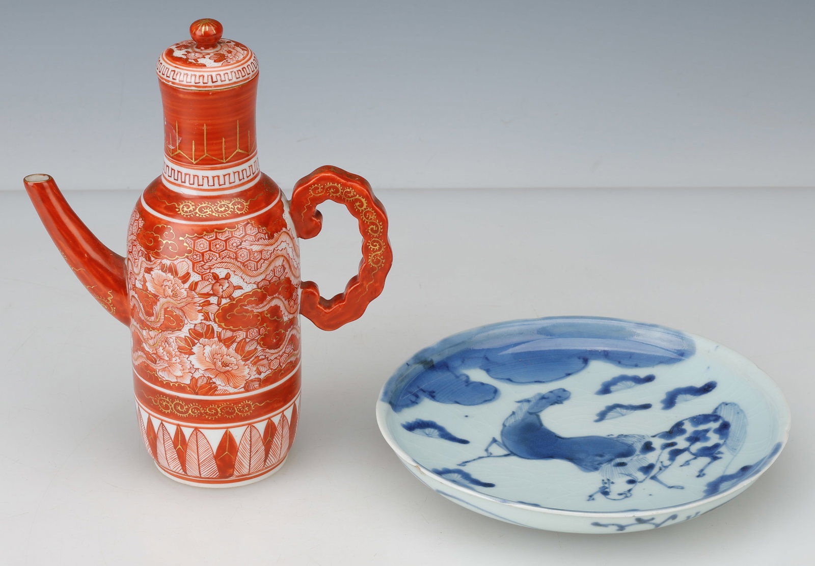 Japanese Kutani Wine Ewer And Porcelain Dish, 19th Century: Japanese Kutani Wine Ewer And Porcelain Dish.19th CenturySizes: 1) 7.25" (18 cm) (plate diameter); 2) 8.5'' x 6'' x 3'' (22 x 15 x 8 cm) (teapot). Provenance: A North American Private Collection.