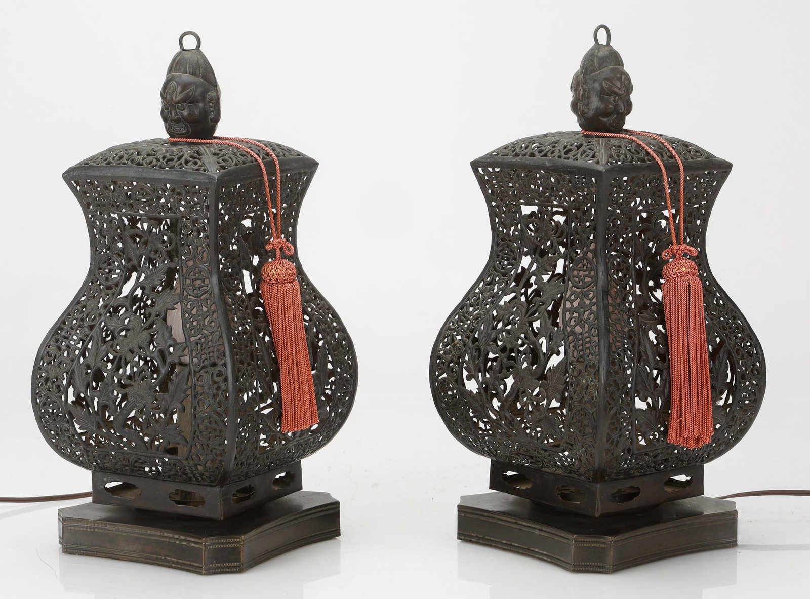 Pair of Chinese Pierced/Openwork Metal Table Lamps / Lanterns, 19th Century: Pair of Chinese Pierced/Openwork Metal Table Lamps / Lanterns. With floral/vegetal motifs and two-faced finials resembling operatic masks. Late Qing Dynasty. Each Size: 14'' x 6.5'' x 6.5'' (36 x 17 x