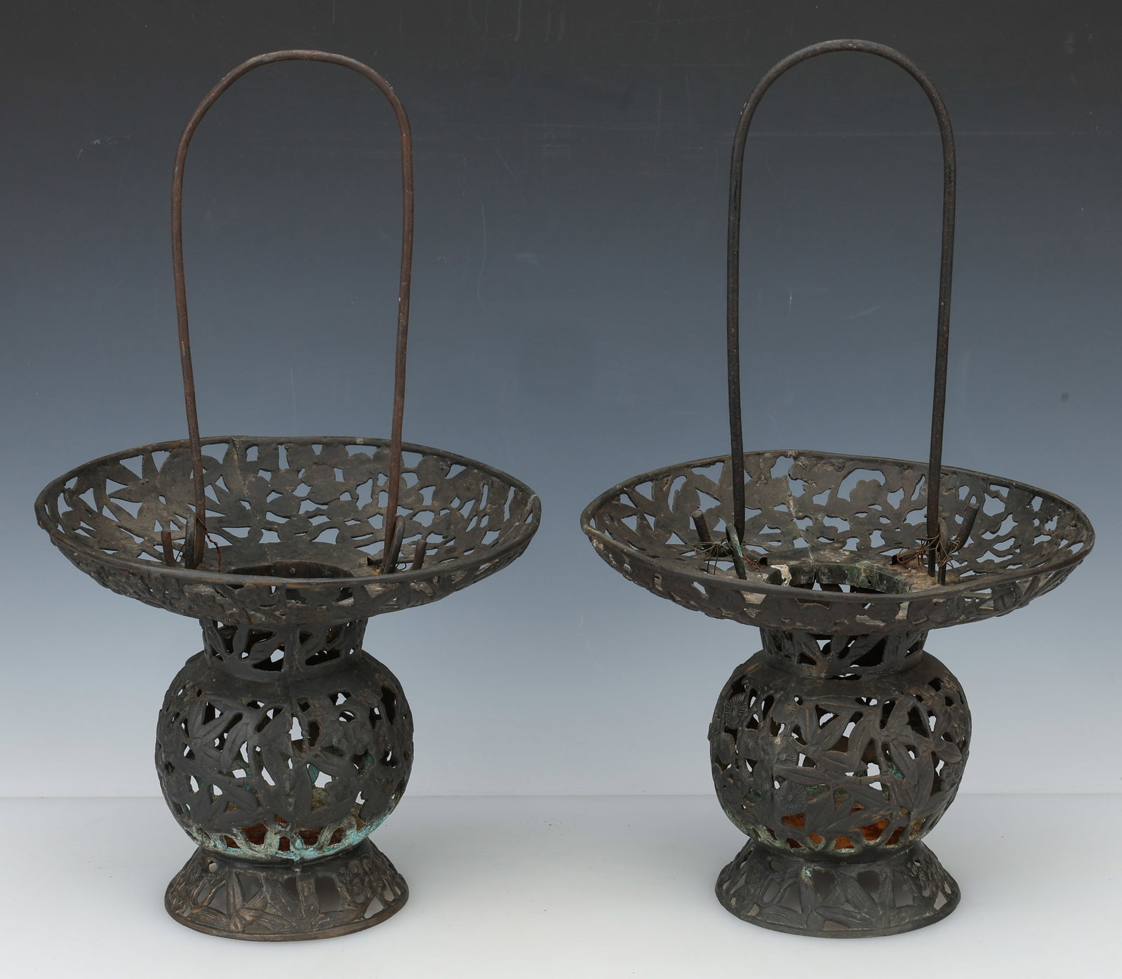 Pair of Chinese Openwork Bronze Lanterns / Lamps, 19th Century: Pair of Chinese Openwork Bronze Lanterns /Lamps. With vegetal motifs and long handles. Late Qing Dynasty. Each Size: 9.5'' x 11'' x 11'' (24 x 28 x 28 cm). Provenance: Private Philadelphia Estate Coll