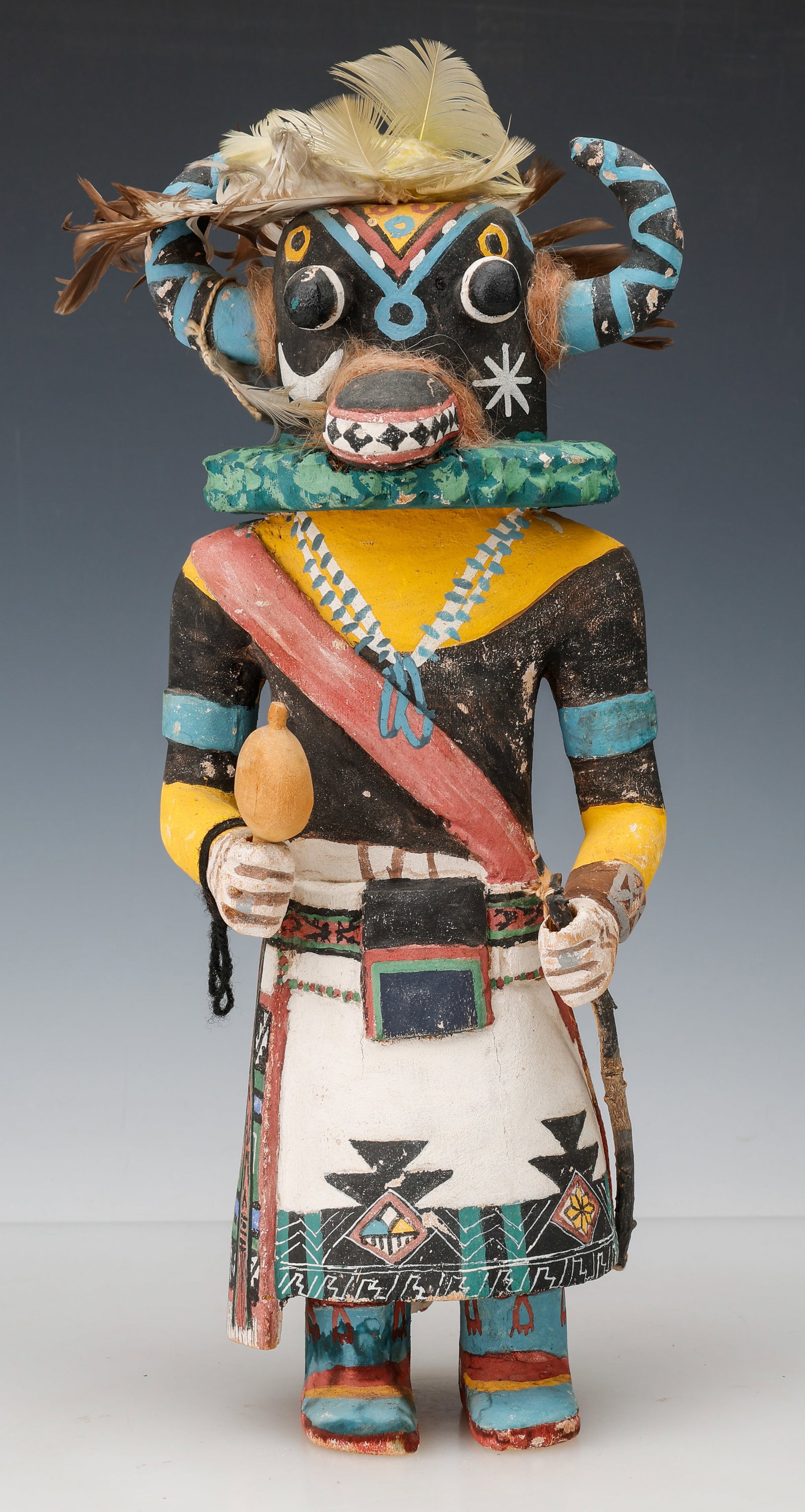 Hopi Ho-o-te, or Ahote, the "Ogre" Kachina Doll, Sotheby's Provenance, H: 15.5": Hopi Cottonwood Kachina Doll. Representing Ho-o-te, or Ahote, the "ogre kachina," holding a rattle and bow, wearing a finely painted typical costume, and large case mask with elaborately carved ruff a