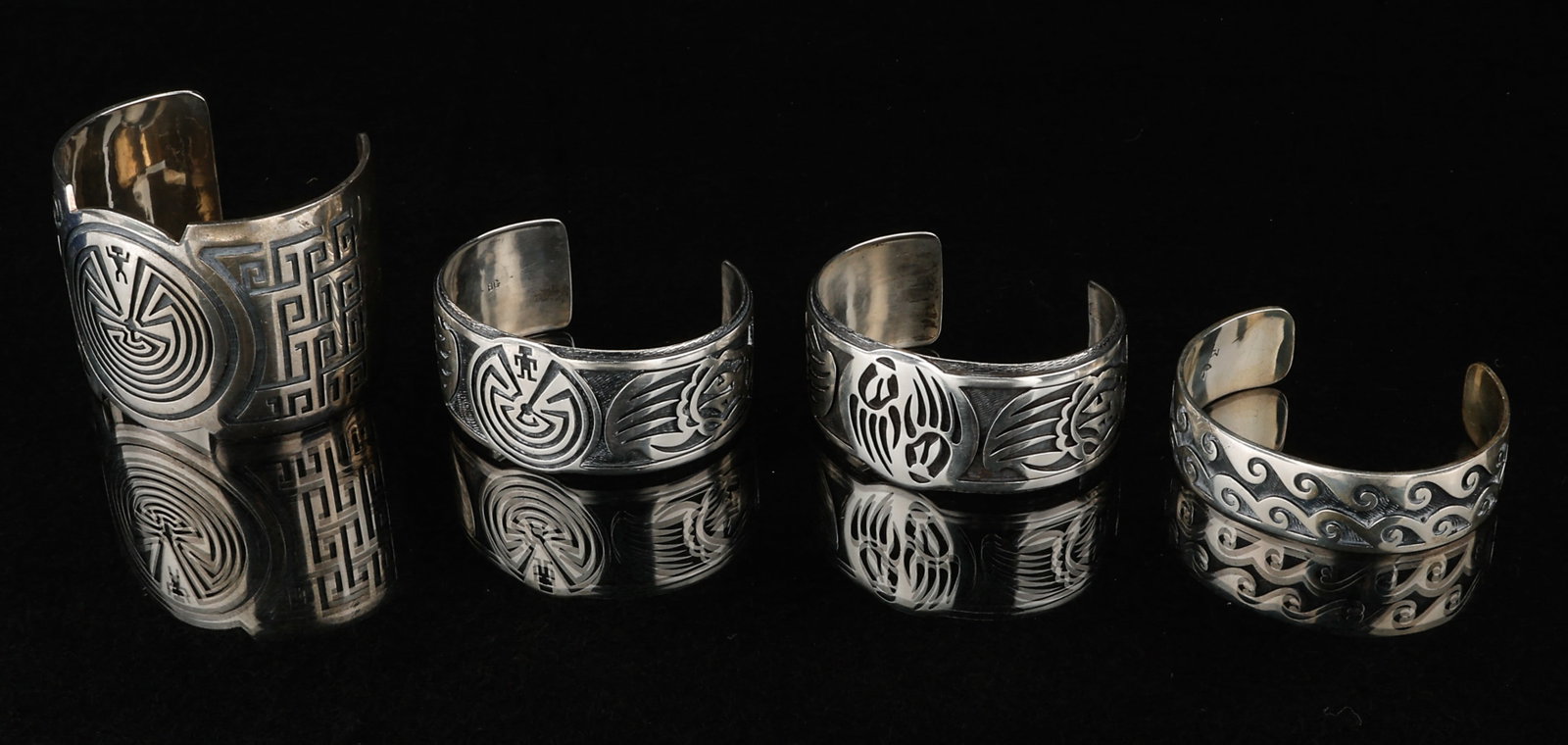 4 Hopi Silver Cuff Bracelets, Weight: 279g: 4 Hopi Silver Cuff Bracelets. Including: 1-2) stamped:BG/ Sterling; and 3-4) stamped: MT. Sizes From: .5'' x 2.5'' (1 x 6 cm); To: 2'' x 2.5'' (5 x 6 cm). Weight: 279g.