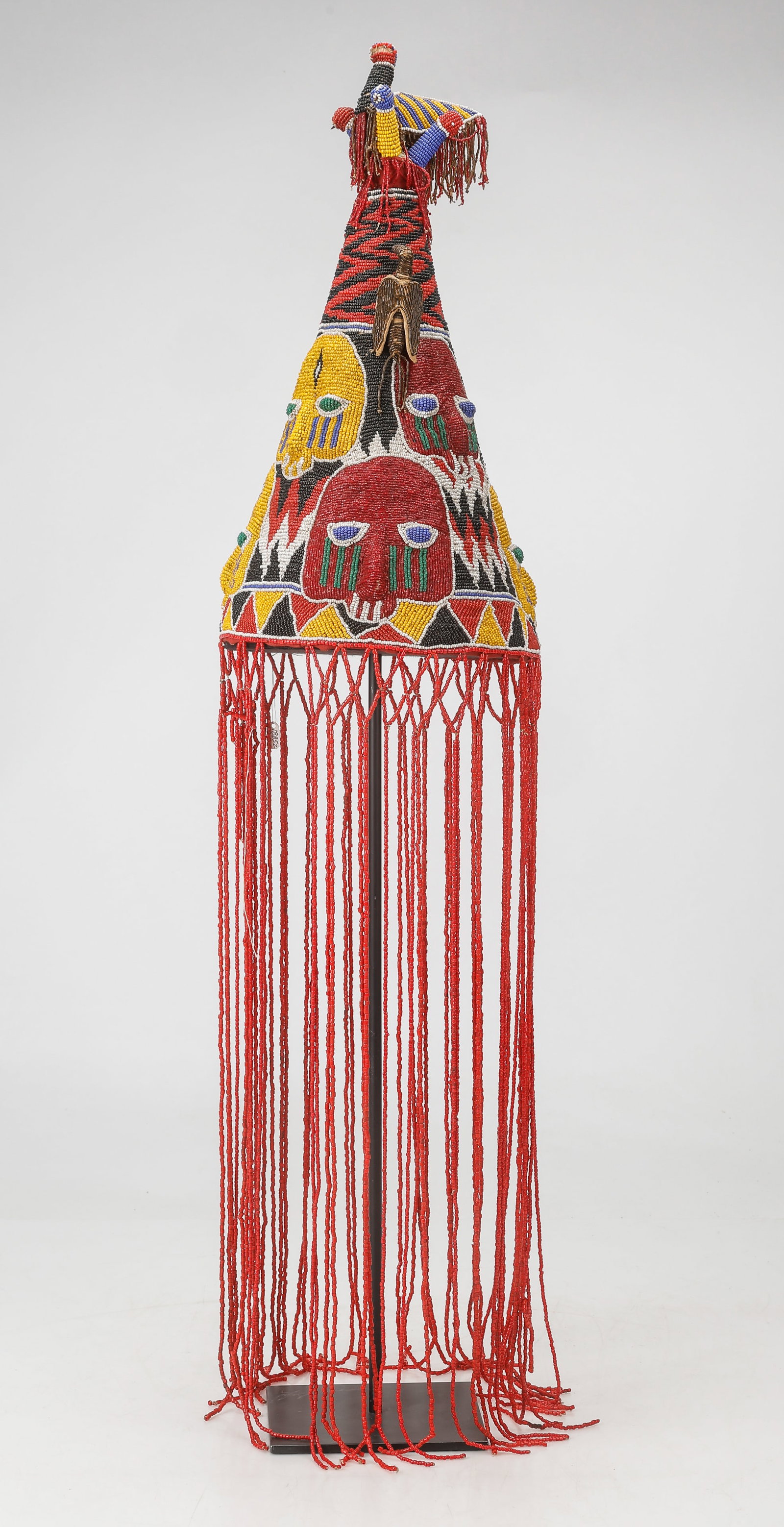 Yoruba Ceremonial Beaded Crown, Nigeria, H: 17", Ex. Douglas Dawson: Yoruba Ceremonial Beaded Crown, Nigeria. On Stand. Size: 17'' x 9'' x 9'' (43 x 23 x 23 cm) (without tassels); Hos: 39" (99 cm). Provenance: Douglas Dawson Gallery, Chicago, IL.