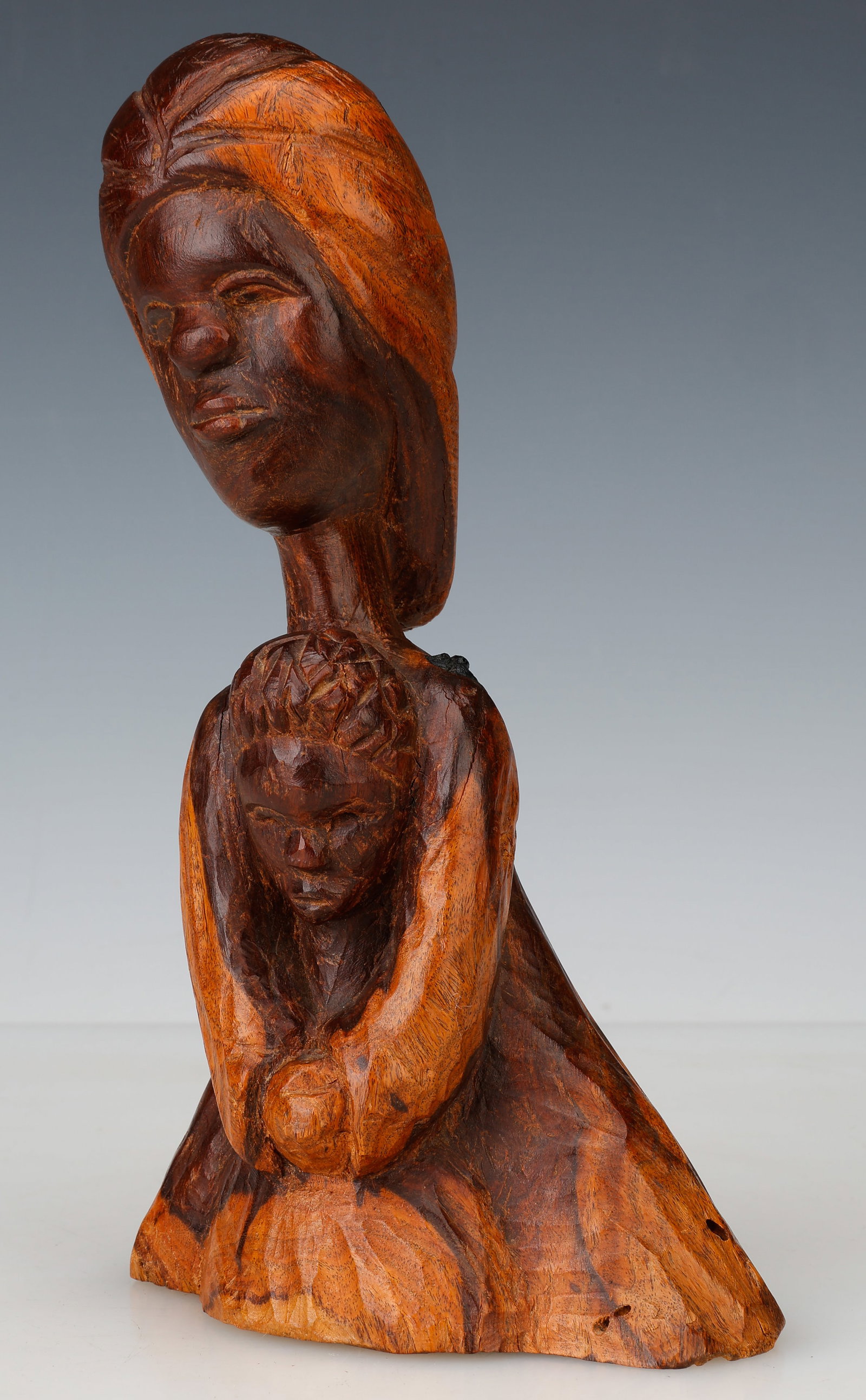 Mallica 'Kapo' Reynolds (Jamaican/Jamaica) Mother And Child, Dated 1969: Mallica 'Kapo' Reynolds (Jamaican, 1911-1989) Mother And Child, dated 1969, carved lignum vitae wood, signed, dated and titled on underside. Size: 9'' x 5'' x 3'' (23 x 13 x 8 cm). Provenance: Acquire