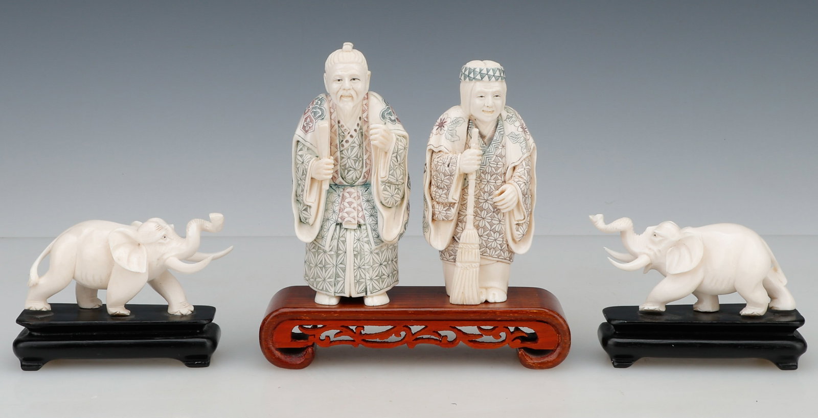 4 Antique Asian Carved Figures: 4 Antique Asian Carved Figures, Including: 2 Japanese Takasago Figures, and 2 Elephants, all on wooden stands. Sizes: 1/2): 2'' x 4'' x 2'' (5 x 10 x 5 cm). Hos: 3" (8 cm); 3/4) 5'' x 2.5'' x 2'' (13 