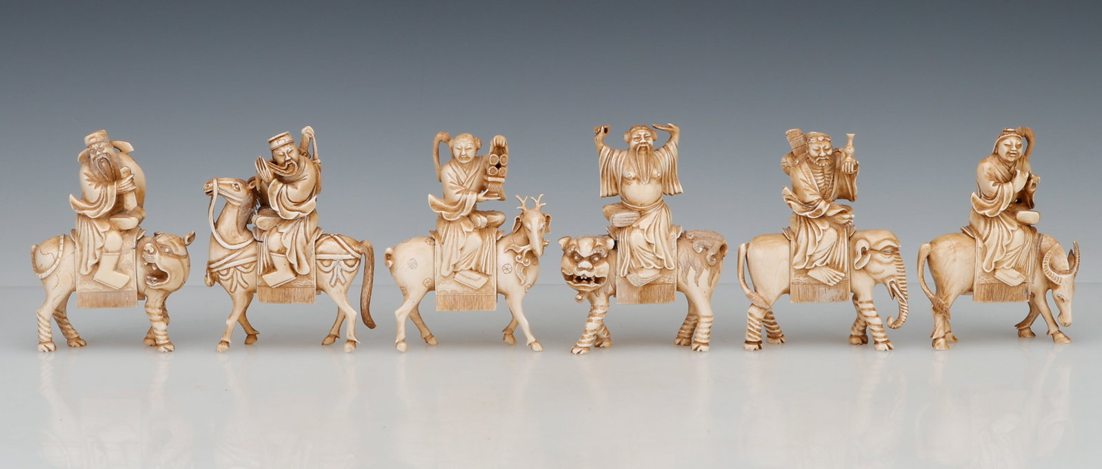 6 Antique Chinese Carved Chess Pieces: 6 Antique Chinese Carved Chess Pieces, featuring figures riding various beasts including horses, elephants, ox, goats, and foo dogs. Each Size Approx.: 5.5'' x 4'' x 1'' (14 x 10 x 3 cm).