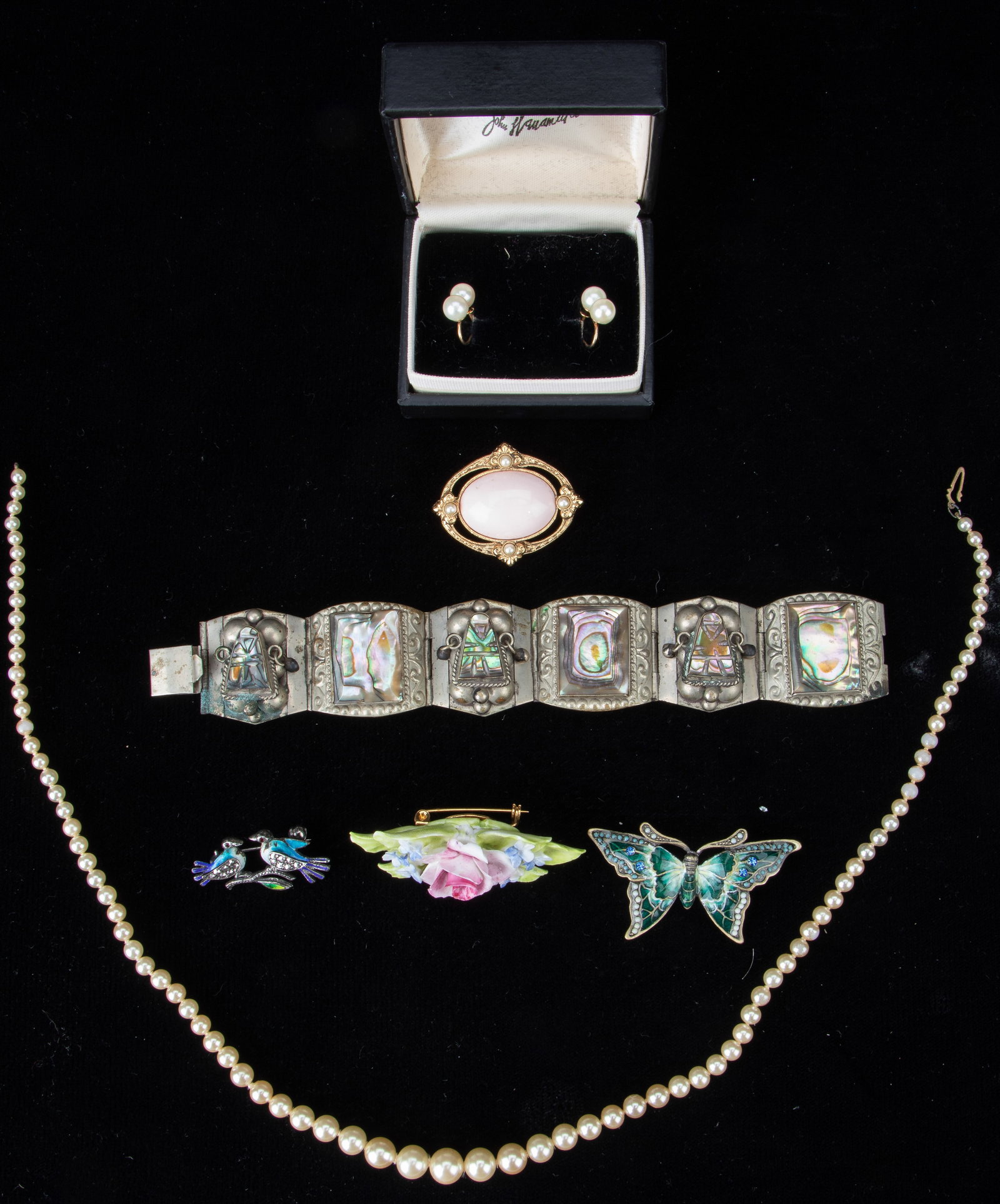 Collector's Lot of Mexican Silver And Pearl Jewelry: Collector's Lot of Taxco Silver And Pearl Jewelry. Including a 7" (18 cm) silver and mother-of -pearl decorated bracelet, stamped: Sterling J0925 Taxco; Pearl necklace, length 18" (46 cm), and brooche