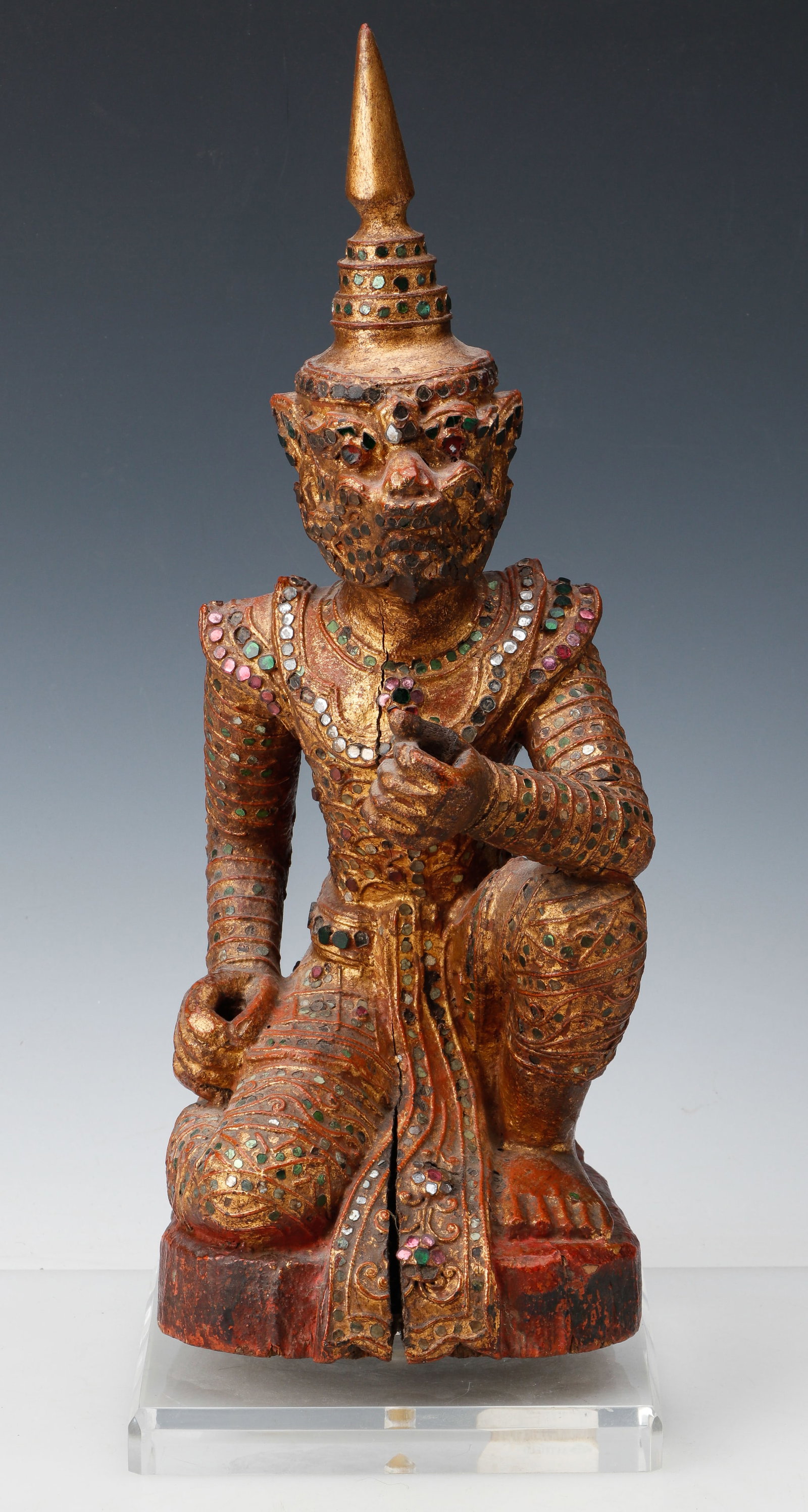 Antique Burmese Bilu Or Hanuman Temple Guardian, 19th C. H: 16": Antique Burmese Bilu Or Hanuman Temple Guardian, 19th C. Gilt lacquered teakwood with glass and stone embellishments. Size: 16'' x 6'' x 7'' (41 x 15 x 18 cm); Height on Stand: 18'' (46 cm). Provenanc
