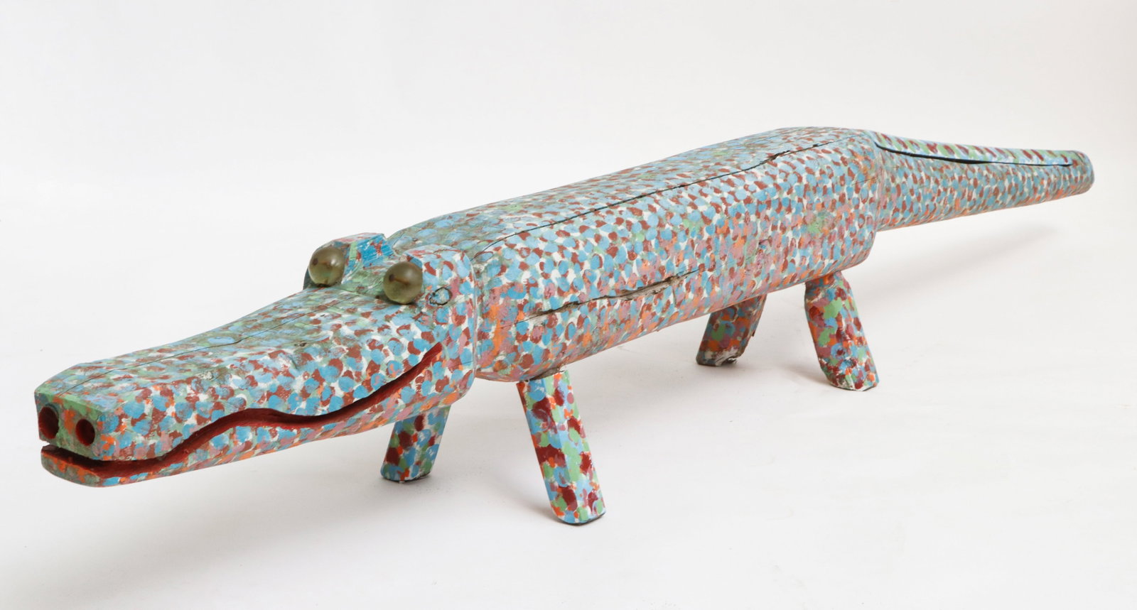 J.L. Nippers (1935-2021) Alligator: J.L. Nippers (American/Beechgrove, Tennessee, 1935-2021) Alligator, chainsaw carved and hand painted cedar wood. Size: 13.5'' x 96'' x 13'' (34 x 244 x 33 cm).