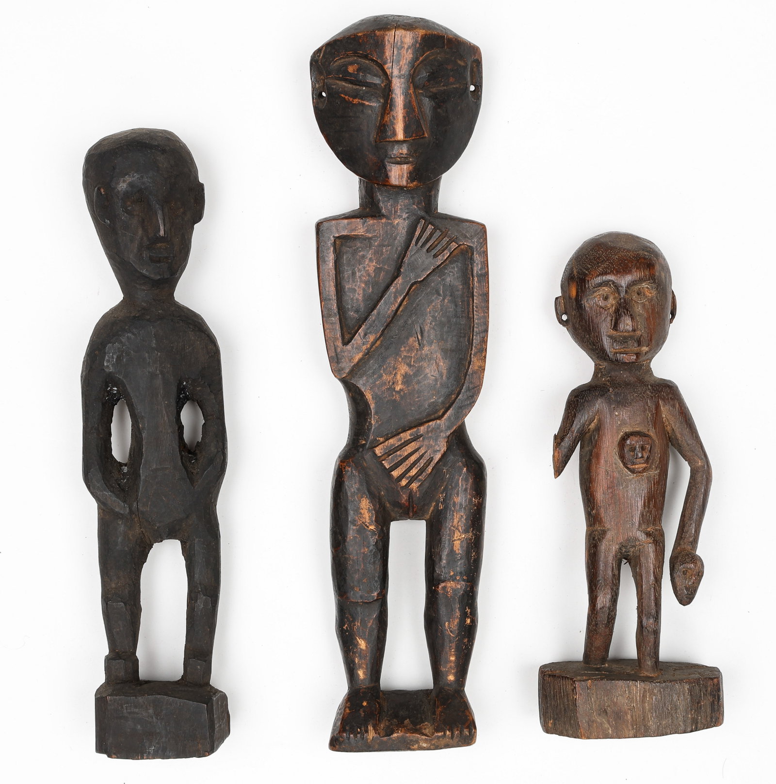 3 Small Figures, NE India: 3 Small Figures, NE India. Carved wood. Features a stylized wooden figure among two other smaller, more traditional simple wooden figures. Possibly taken from a larger wooden plaque in a village morun