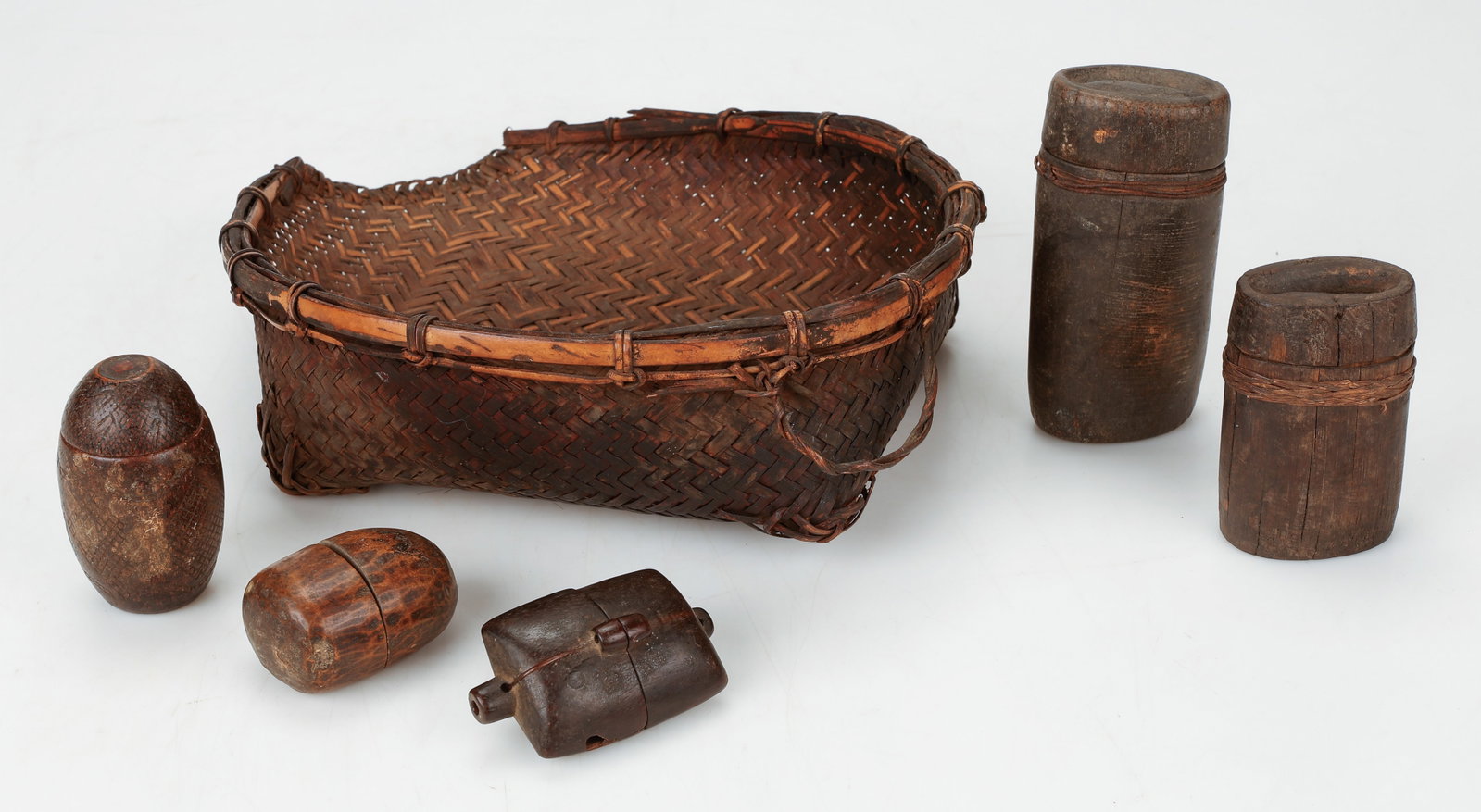 5 Konyak Flint Containers In A Rice Basket, Nagaland, NE India: 5 Konyak Flint Containers in a Rice Basket, Nagaland, NE India. Includes a woven cane rice and seed basket with a group of wooden flint and betel nut containers, which would have been carried in woven