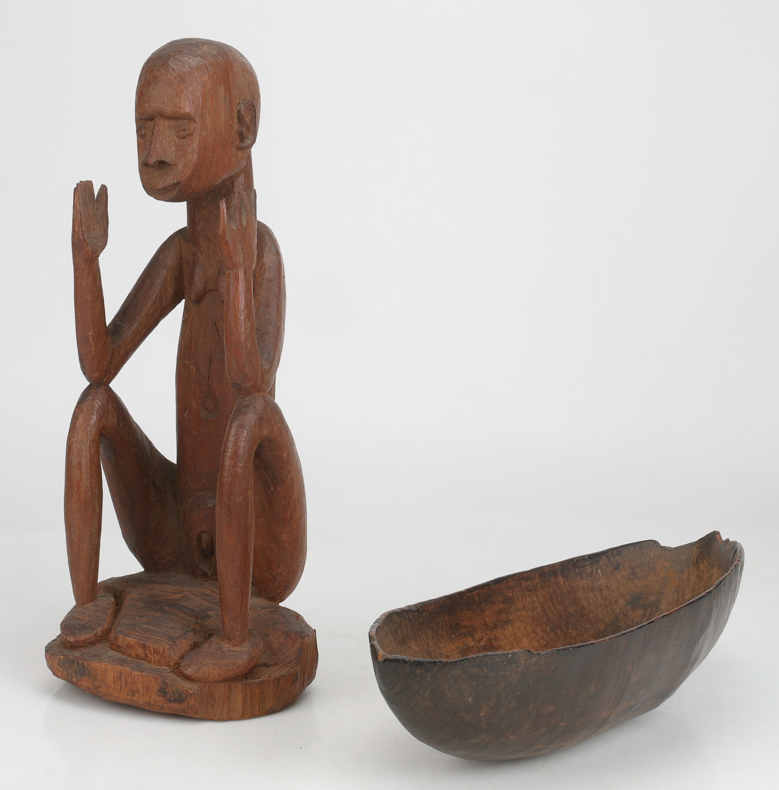 Melanesian Feast Bowl And Ancestor Figure, PNG: Melanesian Bowl and Ancestor Carving, Papua New Guinea. Carved wood, possibly Sepik origin. Sizes: 1) 4.5'' x 20'' x 8'' (11 x 51 x 20 cm); 2) 21.5'' x 9'' x 8'' (55 x 23 x 20 cm).