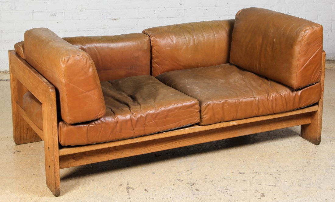 Oak and Leather Loveseat: Oak and Leather Loveseat. Size: 27" x 59.5" x 30", 69 x 152 x 77 cm.