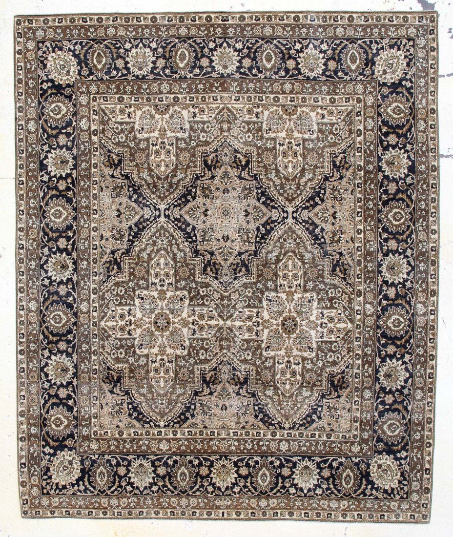 Tebriz Carpet: 9'1" x 11'0": Tebriz Carpet, India, bold pattern of repeat medallions, shades of khaki, beige, charcoal; low overall pile. Size: 9'1" x 11'0". Cost for us to pack and ship this item via UPS GROUND in the continenta