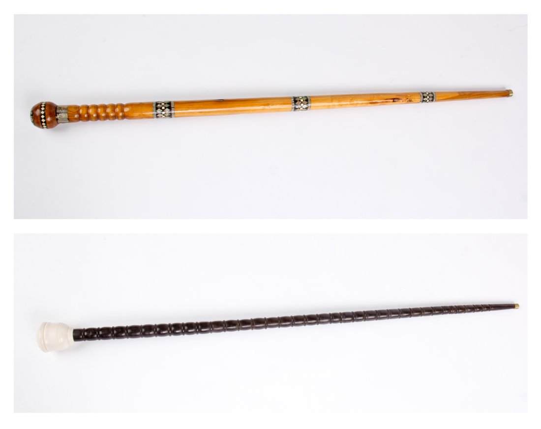 Two Egyptian Walking Sticks: Two Egyptian Walking Sticks. One Stick with Round Knob & Inlays; Another Stick with Turned Ebony Body & Ivory Knob. Collected in Luxor, Egypt. Size: 37" x 1" x 1" (largest).