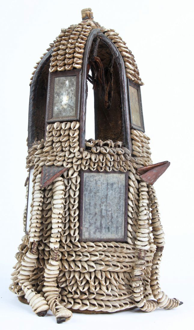 African Yoruba "Ile Ori" or House of Head, Nigeria: African "Ile Ori" or House of Head by the Yoruba people of Nigeria. Leather, mirror and cowrie shells. First half of 20th century. Size: 22" x 9" x 9" (56 x 23 x 23 cm). Provenance: private Montreal c