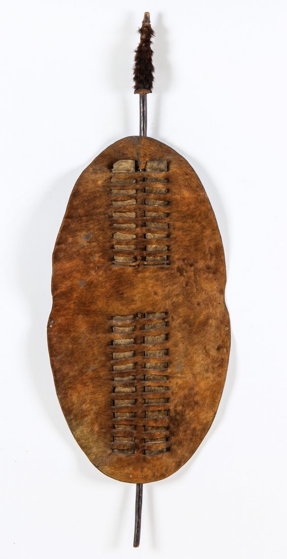 African Hide Shield: African Hide Shield. Featuring a wooden stave through interlaced design. Size: 51" x 18" x 2.5", (130 x 46 x 6 cm). Provenance: Suburban Philadelphia collection.