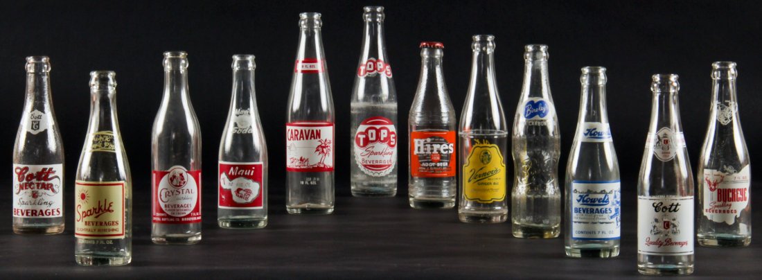 12 Vintage Glass Bottles, various sizes: 12 Rare Vintage Glass Bottles, various sizes. Including Cott Nectar Sparkling Beverages, Sparkle, Crystal, Maui Soda, Caravan, Tops Sparkling, Hires, Vernor's, Bireley's, Howel's, Cott, Buckeye.Jonath