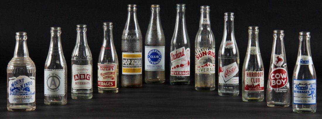12 Vintage Glass Bottles, various sizes: 12 Rare Vintage Glass Bottles, various sizes. Including: Mount Kineo, Circle "A" Brand, ABC Beverages, Tater's, Pop Kola, University Club Beverages, Orchard, Sun Rise, Oscar's, Harmony Club, Cow Boy,