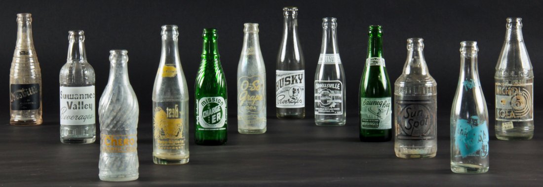 12 Rare Vintage Glass Bottles, various sizes: 12 Rare Vintage Glass Bottles, various sizes. All with single color applied labels. Including Nesbitt's of California (Under License), Suwannee Valley Beverages, Coca-Cola Bottling CO. (Trenton, Fla.)