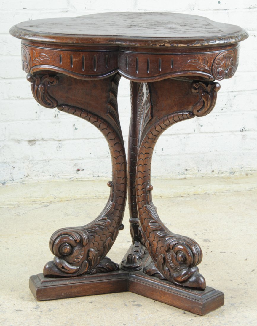 Antique Mahogany Tripod Dolphin Stand: Antique mahogany neo-classically carved stand with trefoil lobed and molded top over dolphin form tripod legs. Size: 26" x 22" x 22" (65 x 55 x 55 cm). Kristina Barbara Johnson Estate, Princeton, New 