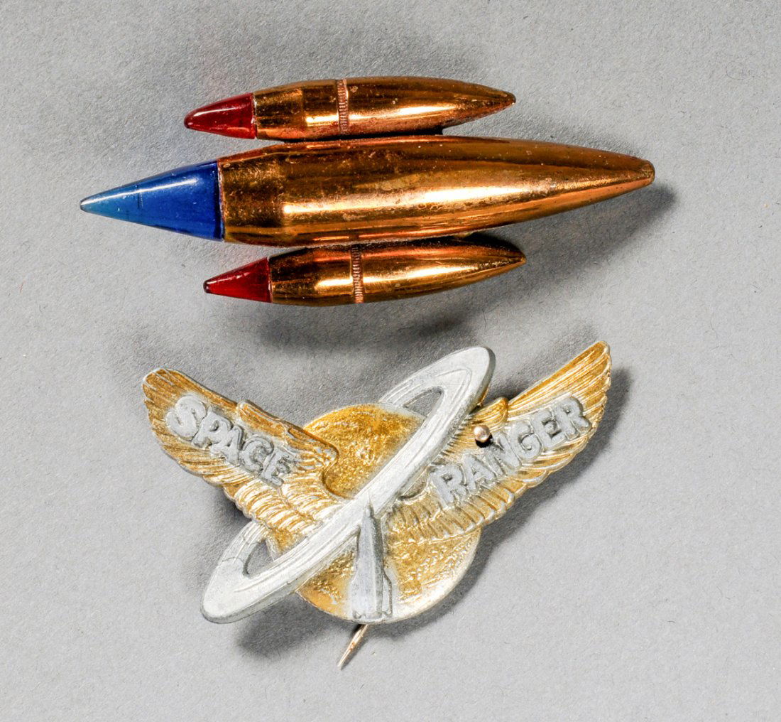Lot of 2 Space Age Brooches: Lot of 2 Space age brooches. One in the form of space ship the other an emblem of the "Space Ranger." Size: 2.5" x 1.5" (6 x 4 cm) to 2.75" x 1" (7 x 3 cm). Kristina Barbara Johnson Estate, Princeton,