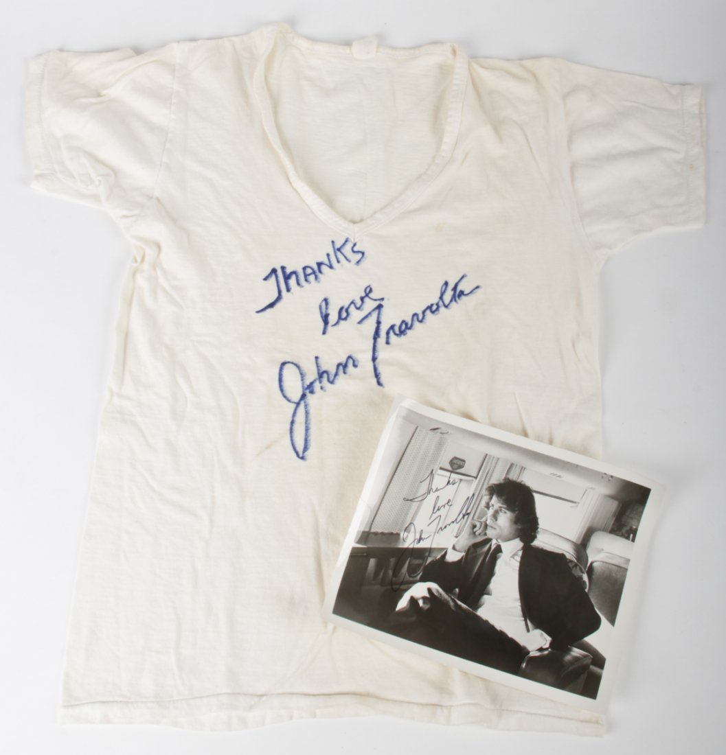 John Travolta Autographed T-shirt and Photograph: John Travolta Autographed T-shirt and Photograph. Sizes: Large (shirt), 8" x 10", 20 x 25 cm (photo). Kristina Barbara Johnson Estate, Princeton, New Jersey. A portion of auction proceeds to benefit t
