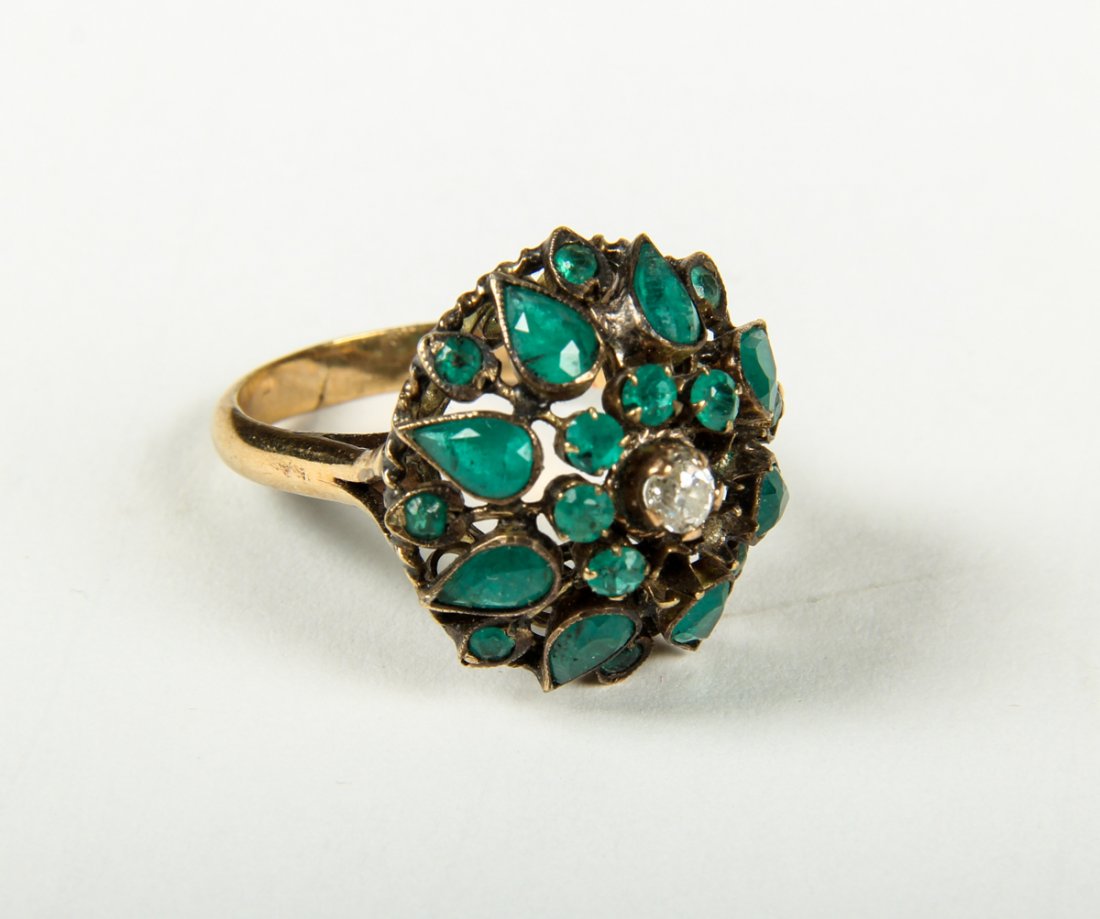 14K Gold India Dome Ring: 14k yellow gold India dome ring set with 5.5 x 3.5 mm. pear and 2.5 mm. round shaped emeralds (some missing) and a round .16 ct. early cut diamond in center. Replaced shank. Weighing 3.2 dwt. Size: 6.