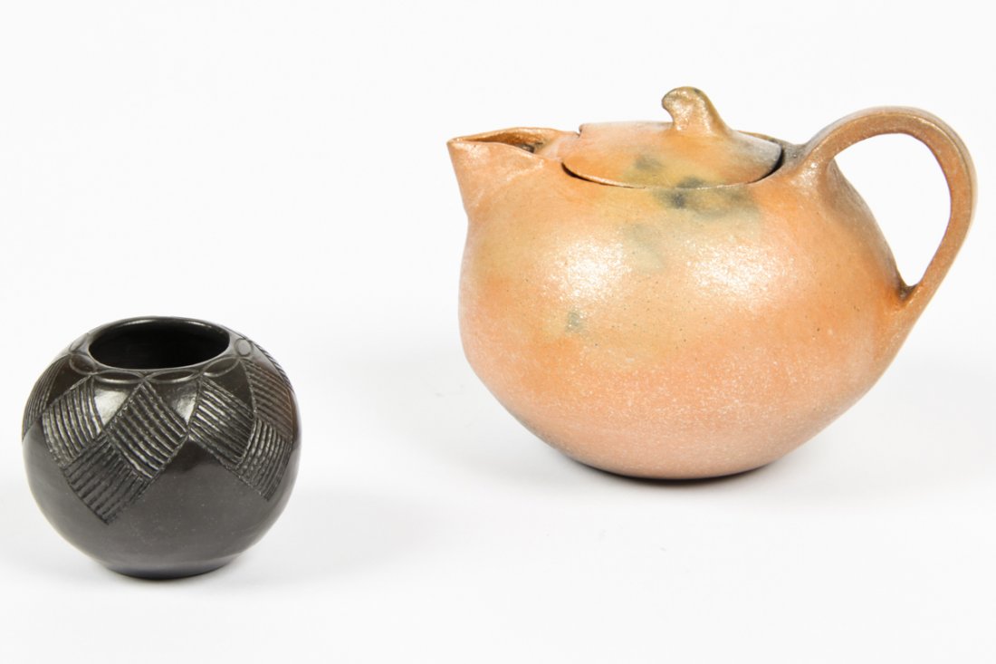 2 Pc Lot of Reservation Pottery: 2 pc lot of Reservation pottery. Earthenware teapot by Felipe Jacinta (sp?), Apache and seed vase by Bigmont (sp?), Cherokee. Size: 5" x 6" x 7", 13 x 15 x 18 cm (Largest).
