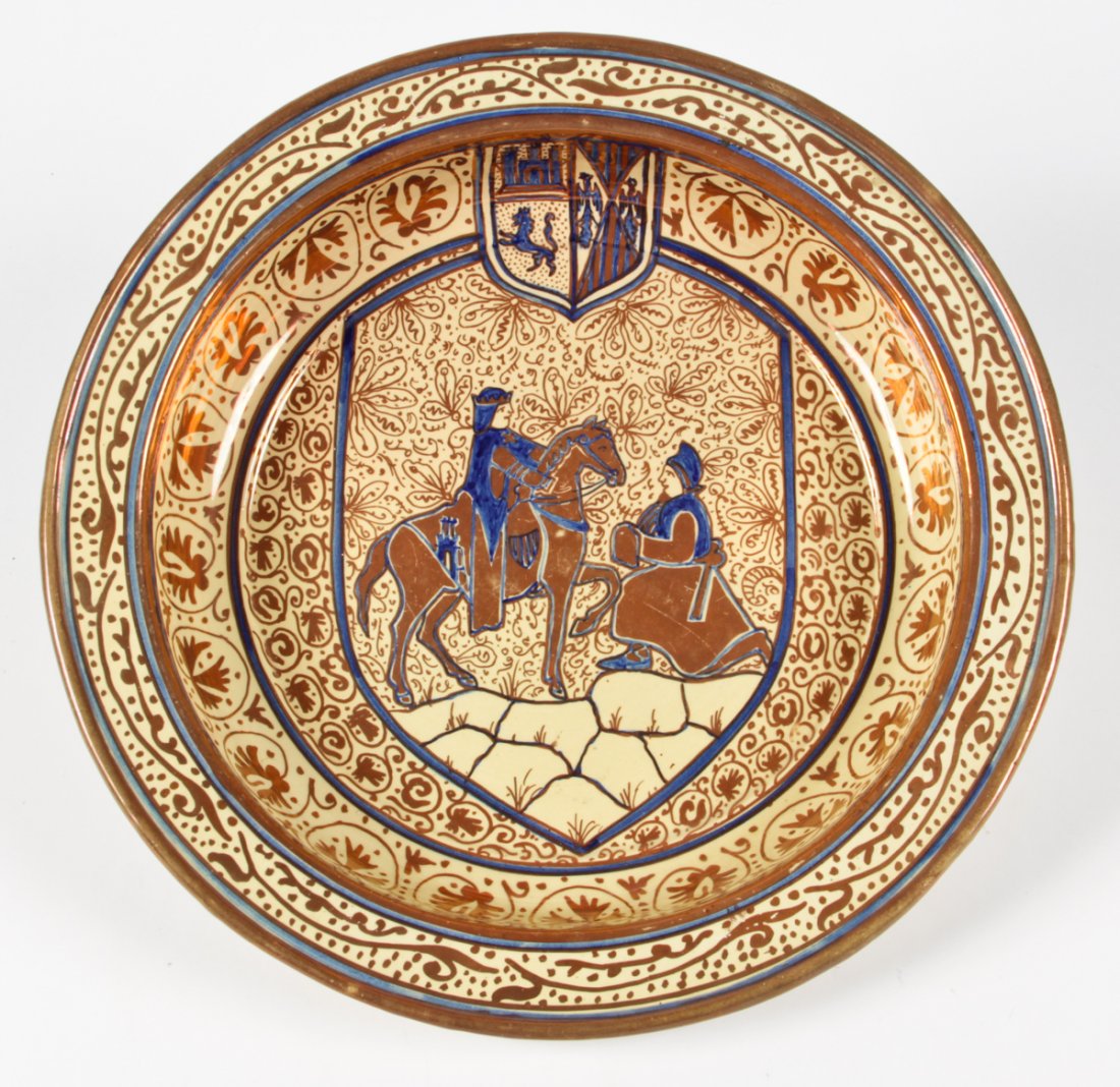 Large Scale Spanish Lustreware Charger: Large Scale Spanish Lustreware Charger. In the style of Manises. Bearing a heraldic shield with a label affixed to the bottom reading "Glou. - Foyle." Size: 16.75" diameter x 2.5" high (43 x 6 cm). Pr