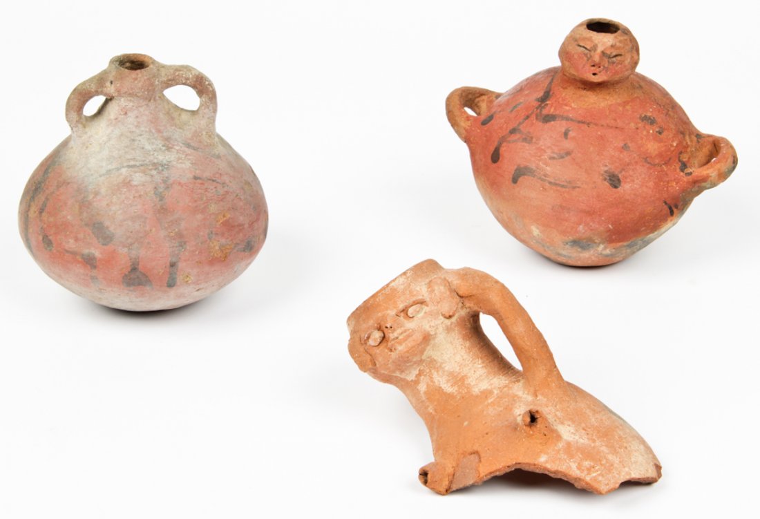 3 Pre-Columbian Earthenware Artifacts: 3 Pre-Columbian Earthenware Artifacts. Consisting of 2 twin handled jugs with figural spouts and a fragment of a jug in the same style. Size: tallest 7" x 8" x 6" diameter (18 x 20 x 15 cm). Provenanc