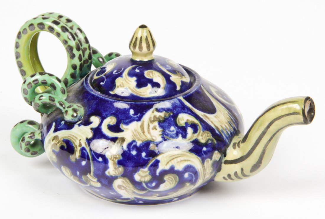 19th C.Chinese Gien France Faience Teapot: Gien France Faience Teapot. 19th C. Chinese. Northwinds motif with figural serpentine handle. Size: 3.5" x 7" x 4" (9 x 18 x 10 cm). Provenance: Private Philadelphia collection.