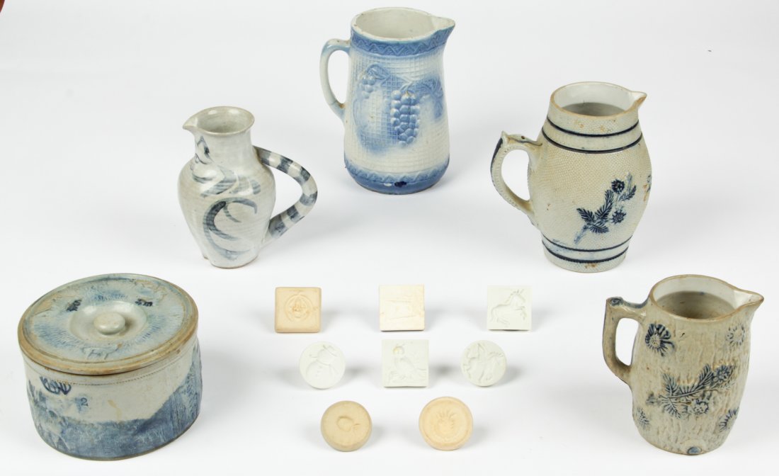 13 Antique Blue and White Pottery Pieces: 13 antique blue and white pottery pieces, including a lidded butter crock with 8 butter stamps, and 4 pitchers. Sizes: 1" x 2" x 2" (3 x 5 x 5 cm), to 9" x 7.5" x 5.5" (23 x 19 x 14 cm).