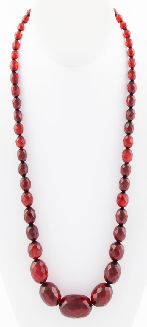 Graduated Polished Amber Bead Necklace: Graduated polished Amber Bead Necklace. Newly Strung. 24"L (61 cm). 56 g. Since 1937, the The Silver Shop of Princeton, NJ was located at 59 Palmer Square West.