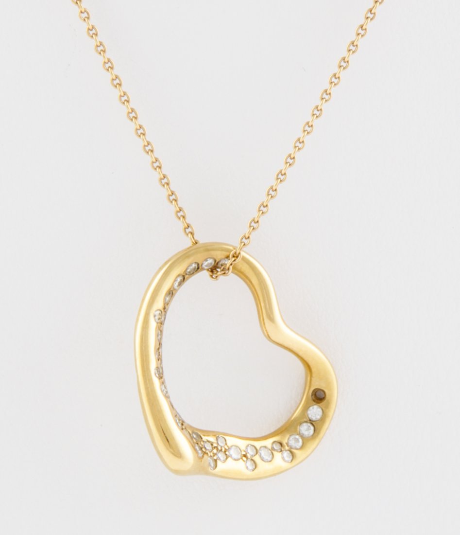 Tiffany 18K Gold and Diamond Heart Pendant: Tiffany Gold and Diamond Heart Pendant suspended on Gold Chain Necklace marked Tiffany & Co 18K Peretti. 16"L (41 cm). 5.6 g. Since 1937, the The Silver Shop of Princeton, NJ was located at 59 Palmer 
