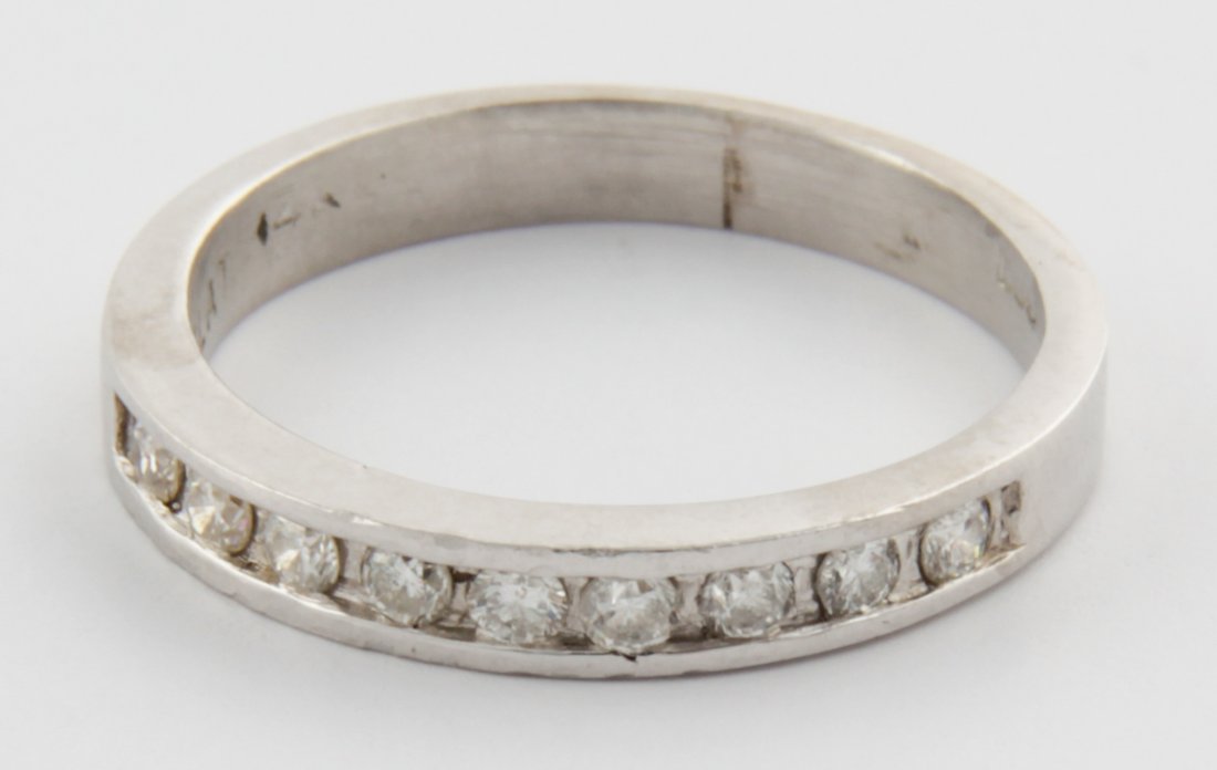 Platinum and Diamond Ring: Platinum and Diamond Ring marked PLAT with channel-set Diamonds at top of Band. Size 5. 3.7 g. Since 1937, the The Silver Shop of Princeton, NJ was located at 59 Palmer Square West.