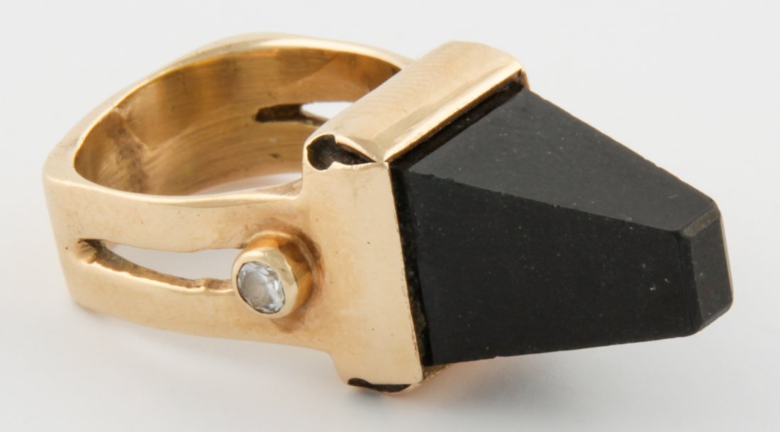 Striking Gold Ring with Obsidian Pyramid: Striking Gold Ring with Obsidian Pyramid set high on a square bezel topping a rounded square Ring featuring a Collet Set Round Diamond on each side. Carved Gold Ring. Studio Creation. One of a Kind. U