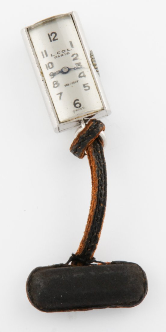 Nickel Silver Watch Pin on Leather Cord marked Juvenia: Nickel Silver Watch Pin on Leather Cord marked Juvenia Mfg Swiss. Size: 1"H (3 cm). Provenance: Doris Duke. 13.7 g.Since 1937, the The Silver Shop of Princeton, NJ was located at 59 Palmer Square West