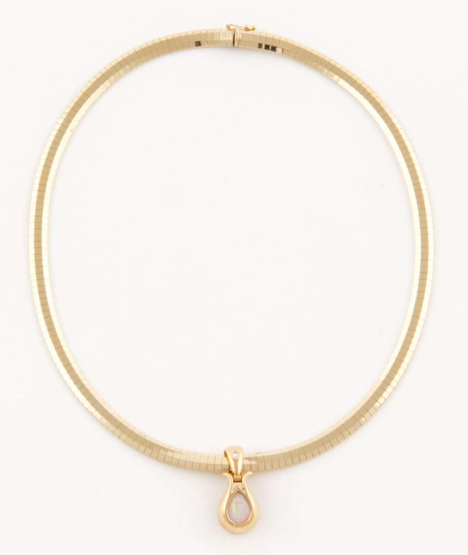 Teardrop Opal Pendant Mounted in 18K Yellow Gold: Teardrop Opal Pendant marked GAR mounted in 18K Yellow Gold suspended on Double-Beveled 14K Omega Necklace. Marked Italy. Contemporary. 16"L (41 cm). 37.6 g.Since 1937, the The Silver Shop of Princeto