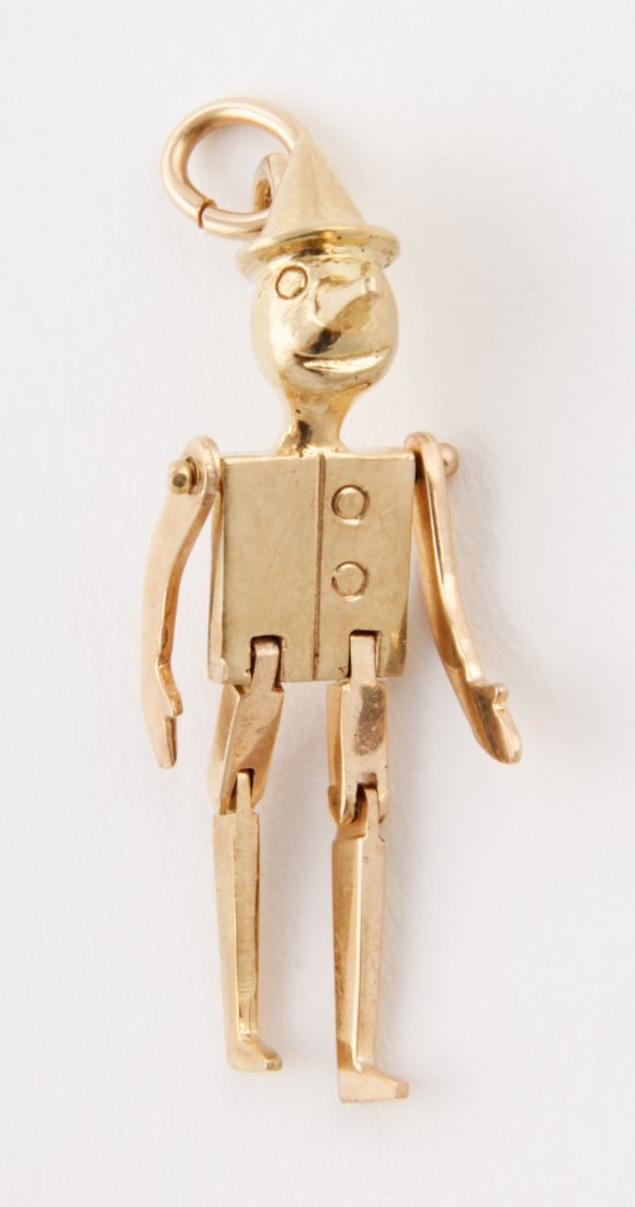 18K Gold Pinocchio Pendant: Gold Pinocchio Pendant. Very Fine and Articulated. Marked 18K. 1.5" x .5" (4 x 1 cm). 0.15 ozt. Since 1937, the The Silver Shop of Princeton, NJ was located at 59 Palmer Square West.