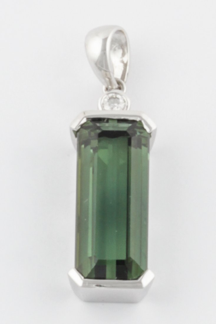 18K White Gold and Green Tourmaline Pendant: 18K White Gold and Green Tourmaline Pendant, marked 18K. 1.25"H (3 cm). 5 g. Since 1937, the The Silver Shop of Princeton, NJ was located at 59 Palmer Square West.