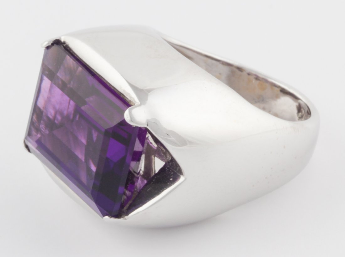 14K White Gold and Amethyst Ring: 14K White Gold and Amethyst Ring. Stunning Gem Amethyst set on its side with abundant Gold Band. Italy. Size 7. 19 g. Since 1937, the The Silver Shop of Princeton, NJ was located at 59 Palmer Square W