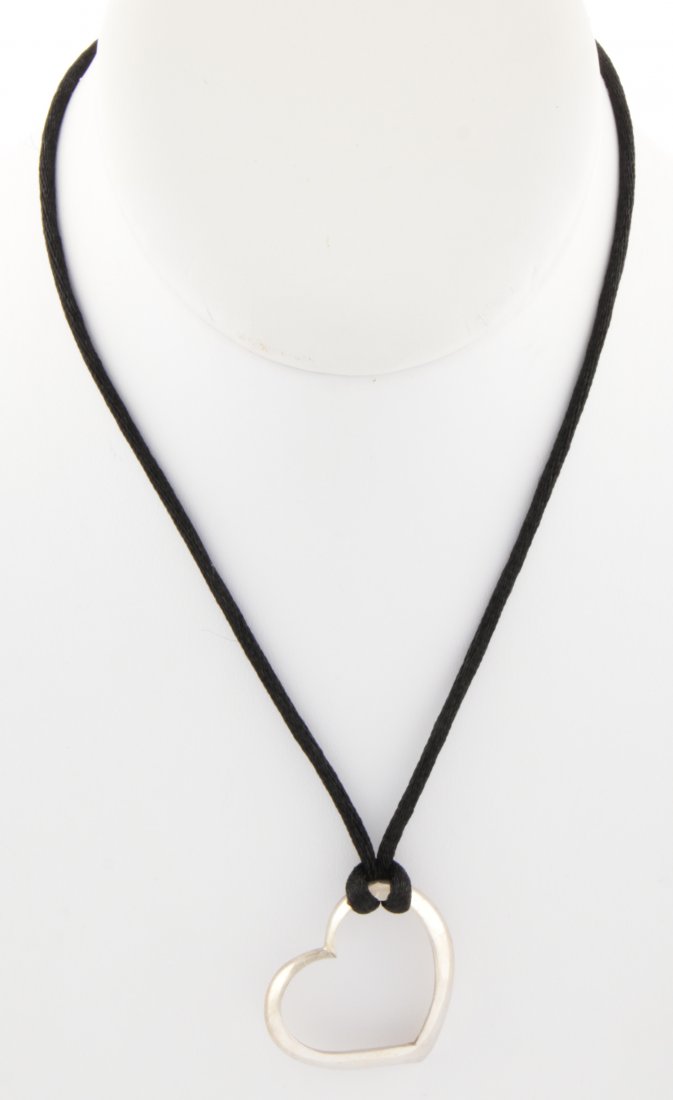 Sterling Silver Heart Pendant Necklace on Silk Cord: Sterling Silver Heart Pendant Necklace on Silk Cord. Size: 1" x 1.25", 2.5 x 3 cm (pendant). 5.9 g. Since 1937, the The Silver Shop of Princeton, NJ was located at 59 Palmer Square West.