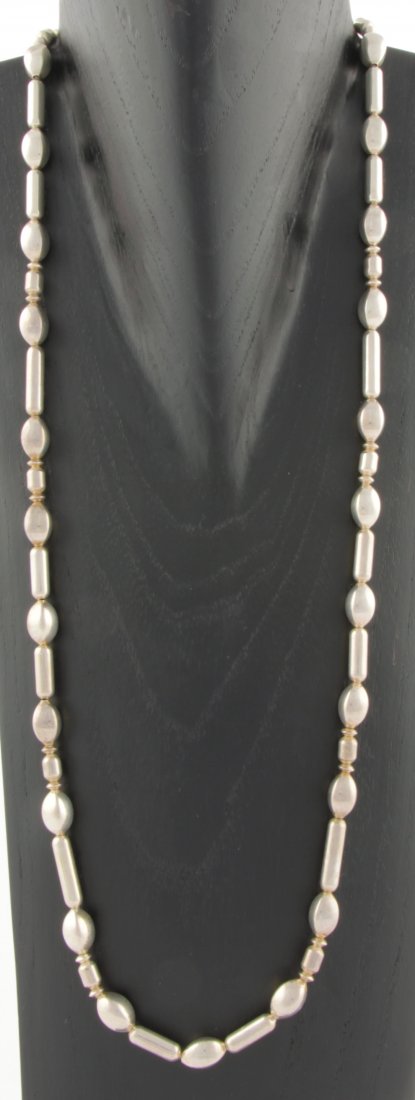 Silver Necklace with Oval and Tubular Beads: Attention-getting Silver Necklace with Oval and Tubular Beads marked Sterling NR. 32"L (81 cm). 68.4 g. Since 1937, the The Silver Shop of Princeton, NJ was located at 59 Palmer Square West.