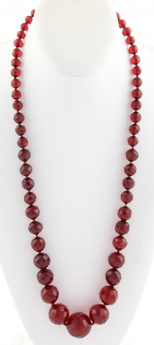 Cherry Amber and 14K Gold Beaded Necklace: Cherry Amber Beaded Necklace newly strung on silk with 14K Gold Clasp. 27"L (69 cm). 66.9 g. Since 1937, the The Silver Shop of Princeton, NJ was located at 59 Palmer Square West.